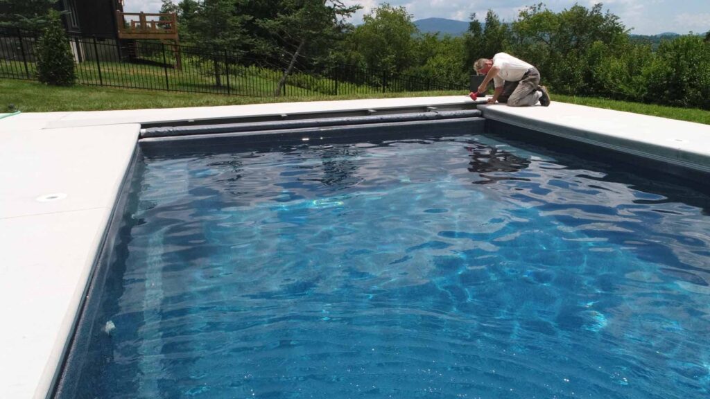 Our team putting the finishing touches on a vinyl pool at a client's home