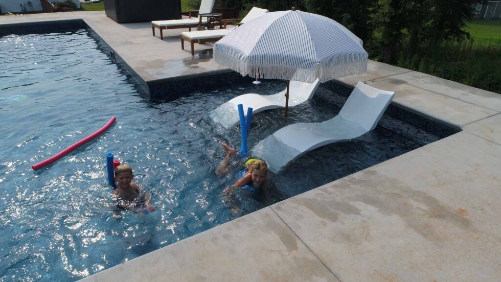 A family enjoying time in an inground pool