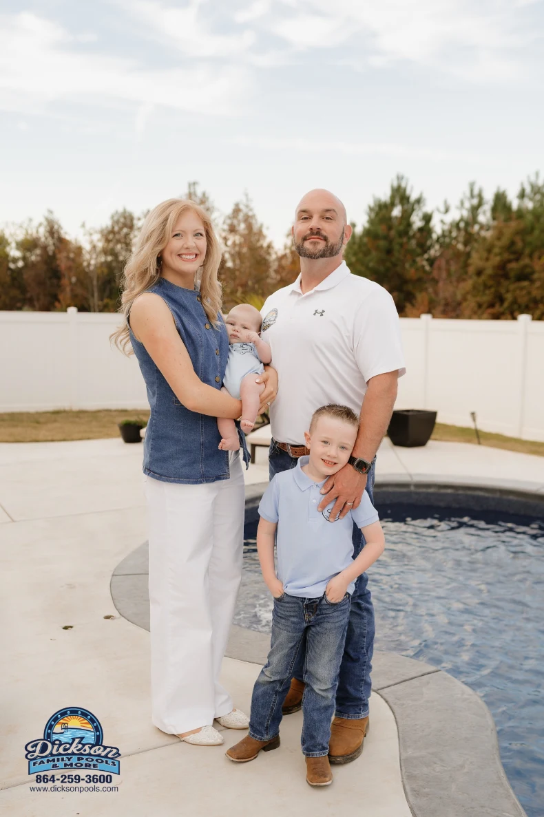 Family of four posing by a backyard pool: mother holding a baby, father beside, older son in front; poolside logo in corner.